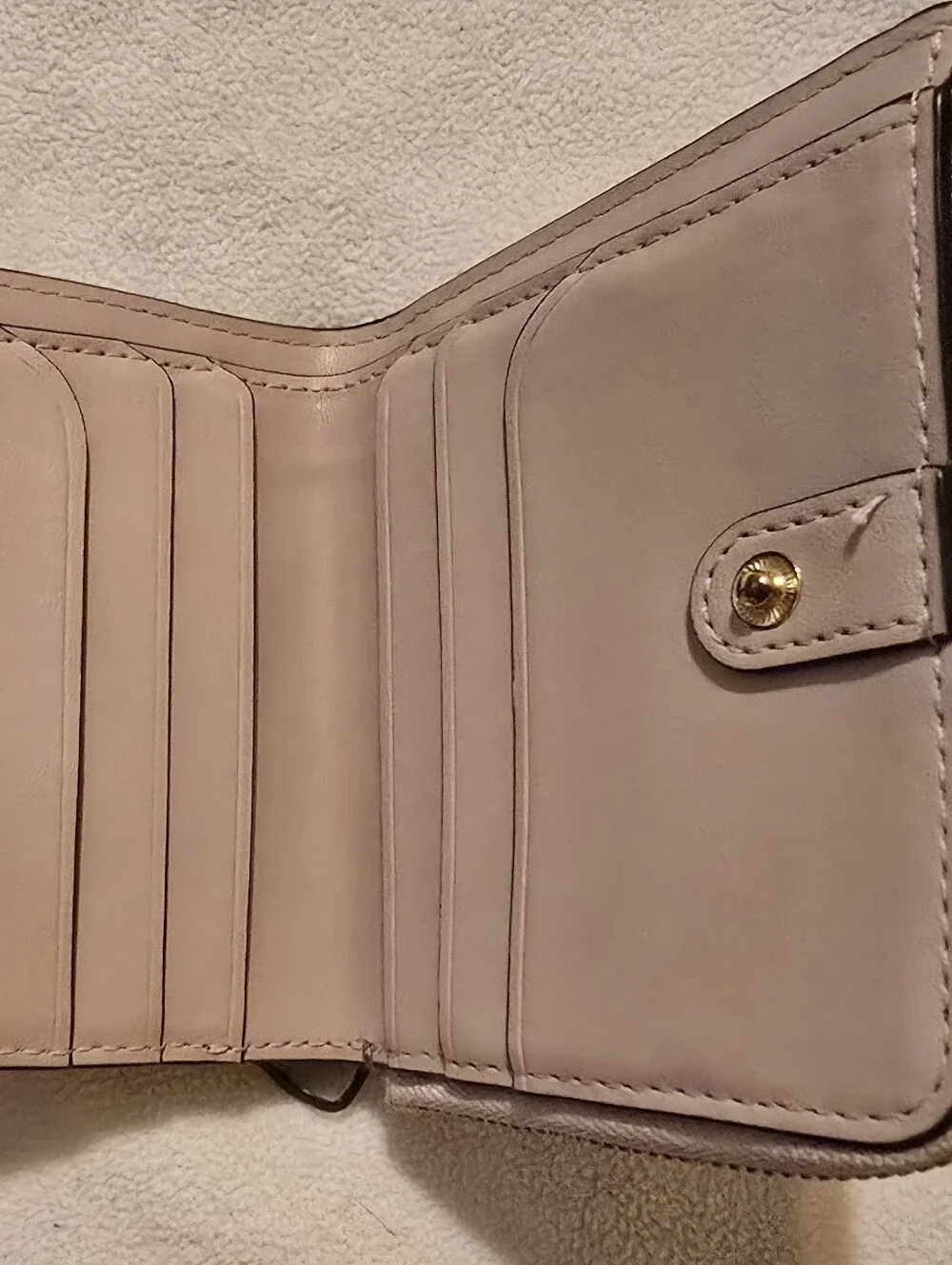 Kate Spade New York Staci small zip-around bifold wallet featuring a glittery ro